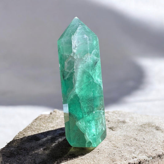 Green fluorite crystal tower with inclusions