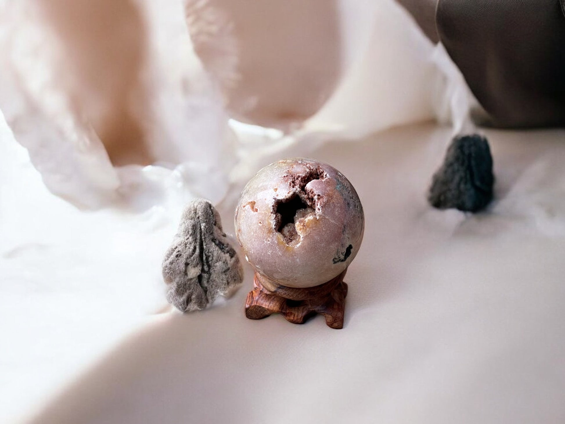 Pink amethyst crystal sphere on a stand