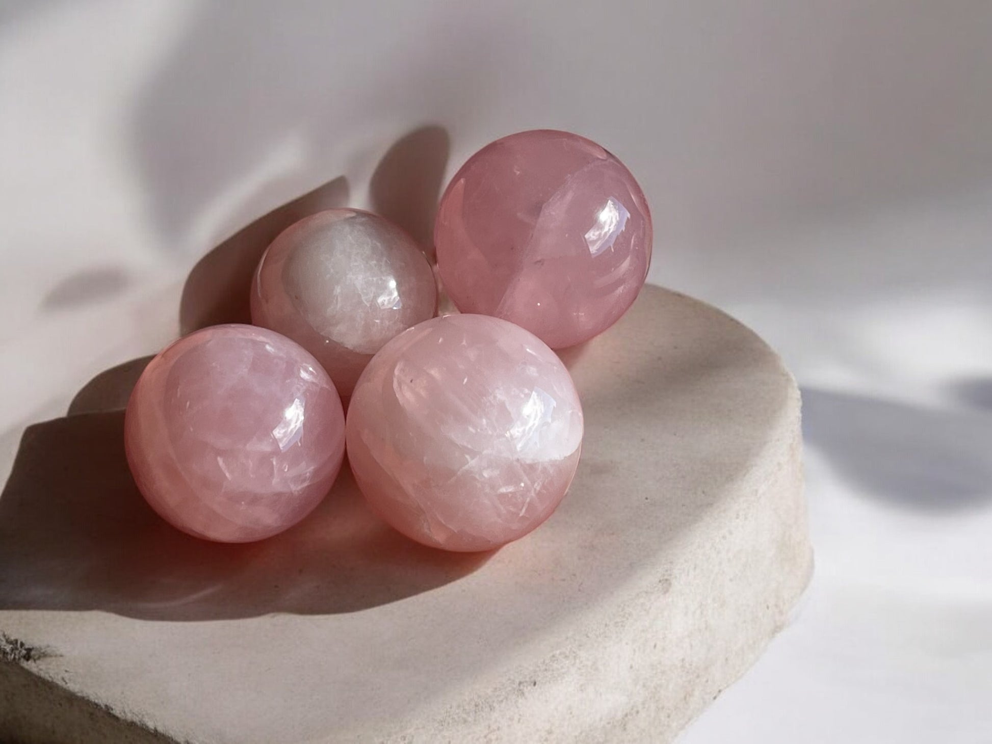 Rose quartz mini crystal spheres on concrete