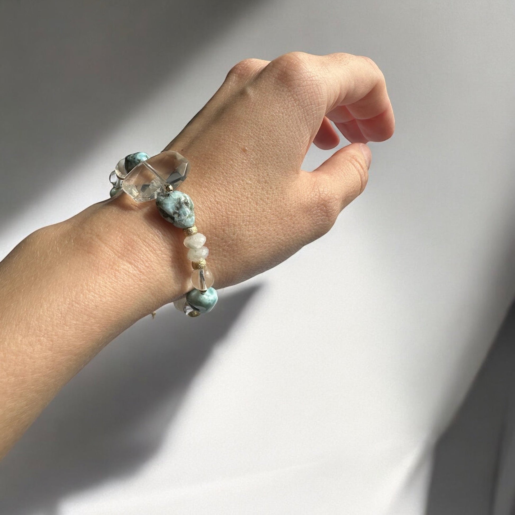 Wearing Larimar, moonstone & clear quartz crystal bracelet