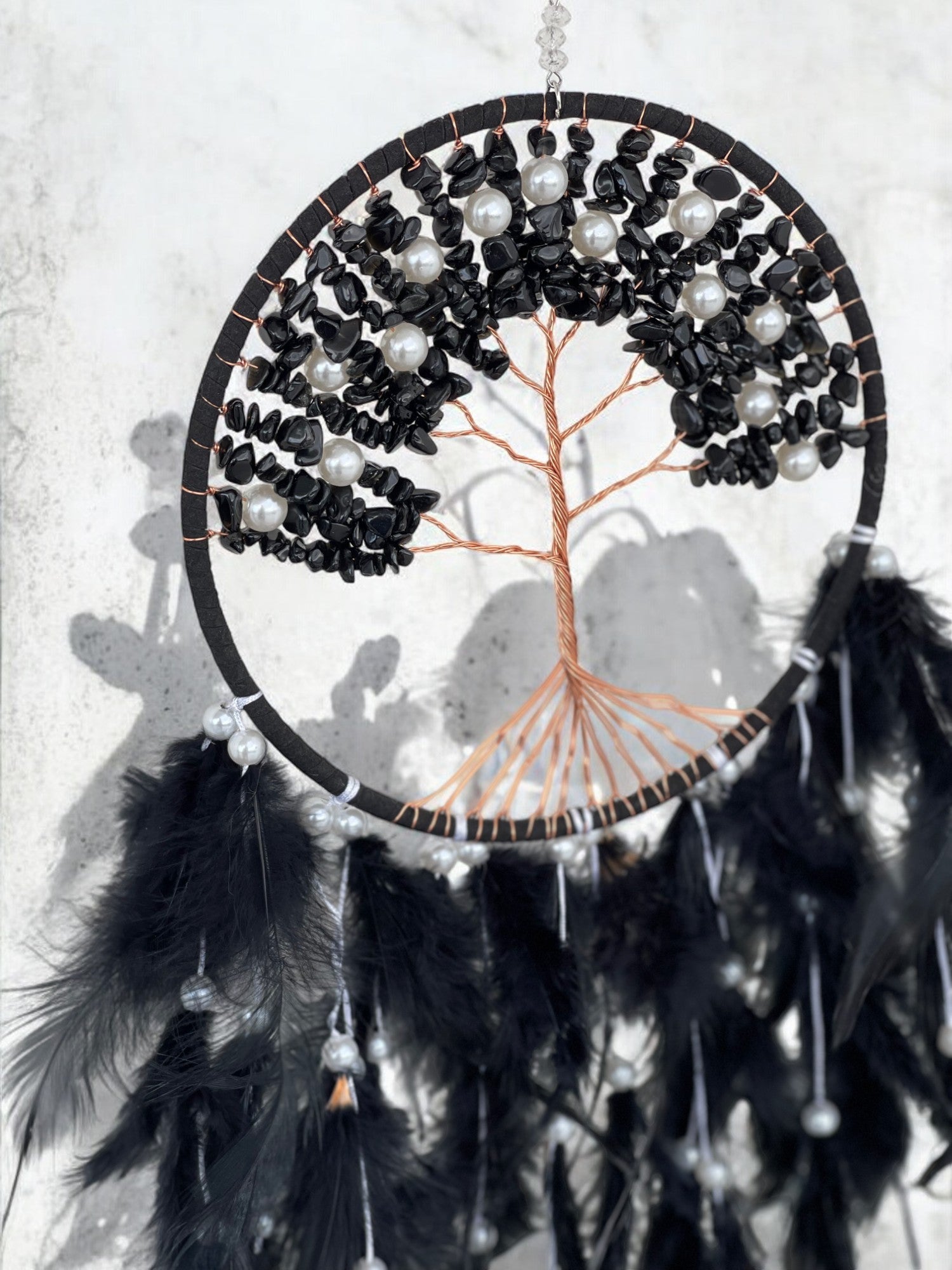 Black onyx crystal dreamcatcher on a wall