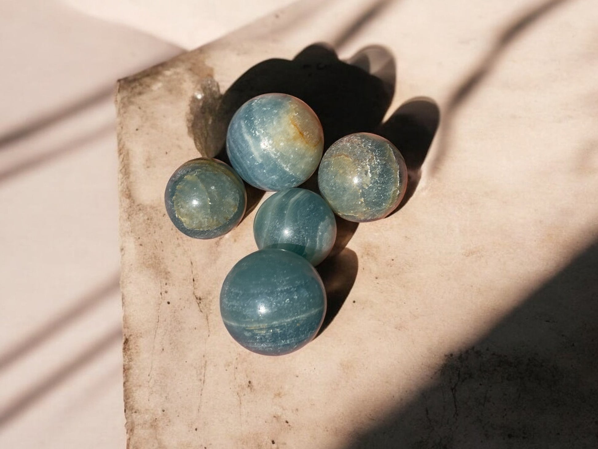 Blue onyx crystal spheres on a concrete