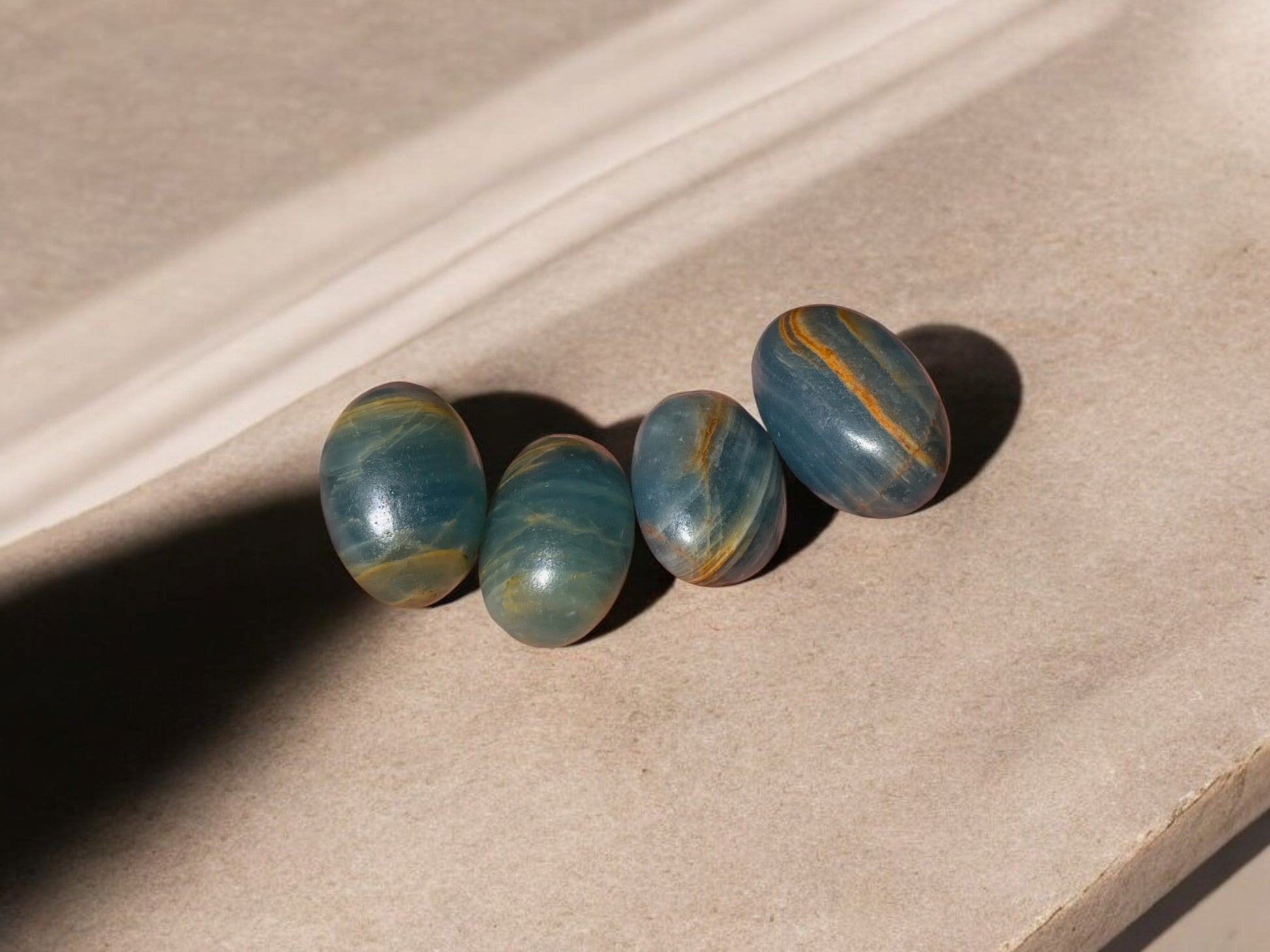 Blue onyx tumbled stones on a concrete