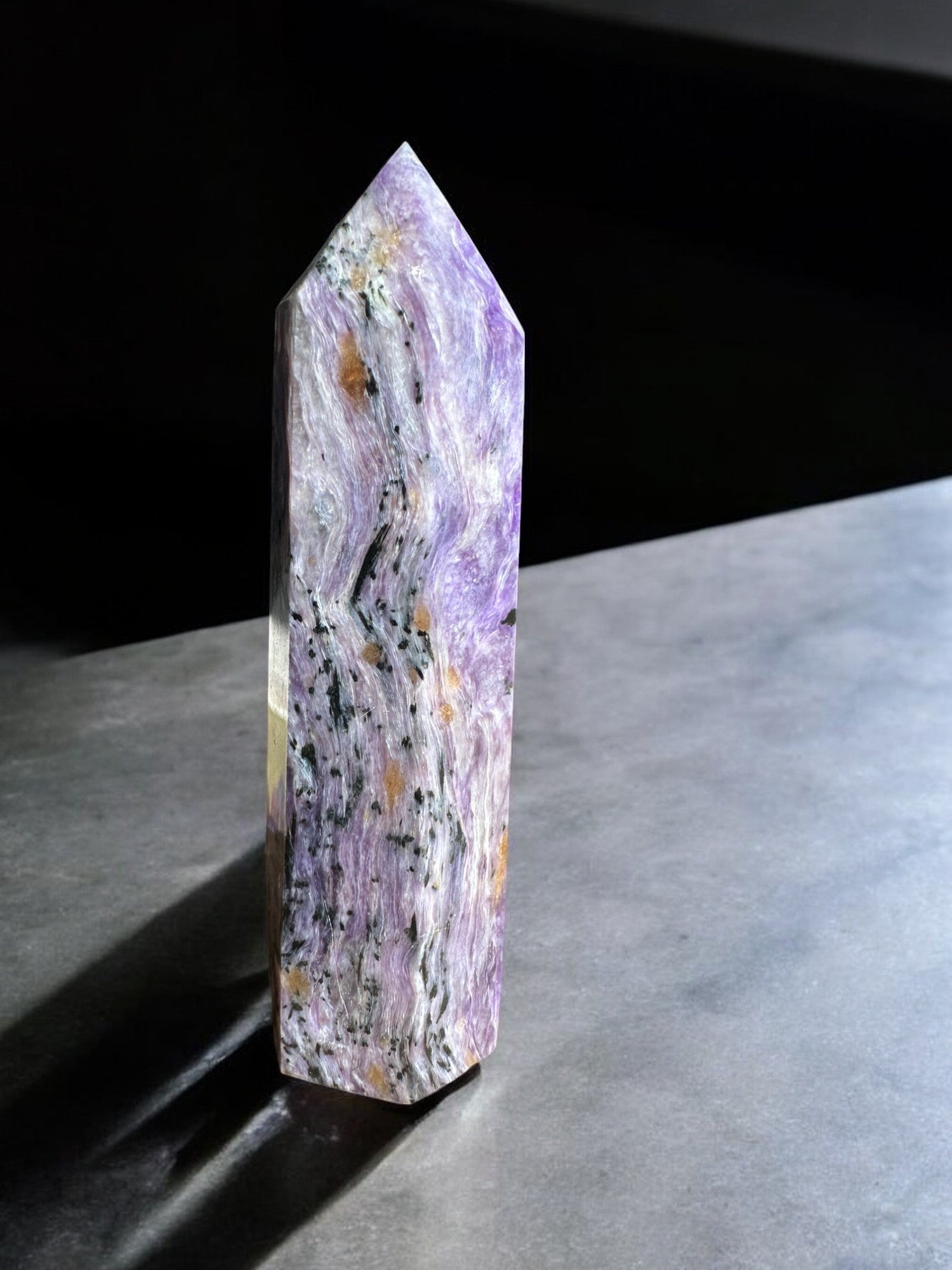 charoite crystal tower with black inclusions