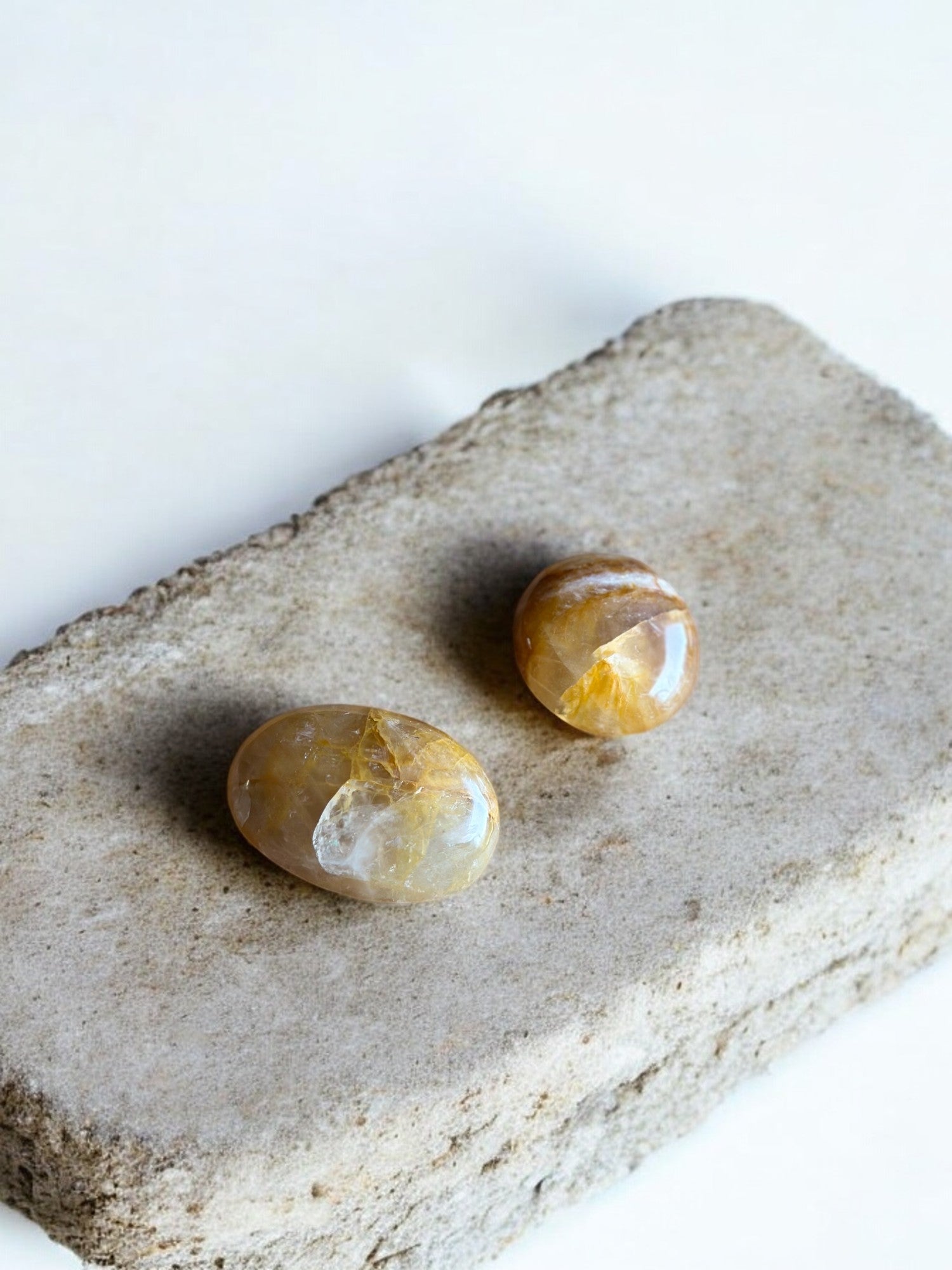 Golden healer quartz palm stones on a slab