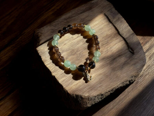 green aventurine and smoky quartz crystal bracelet on a slab