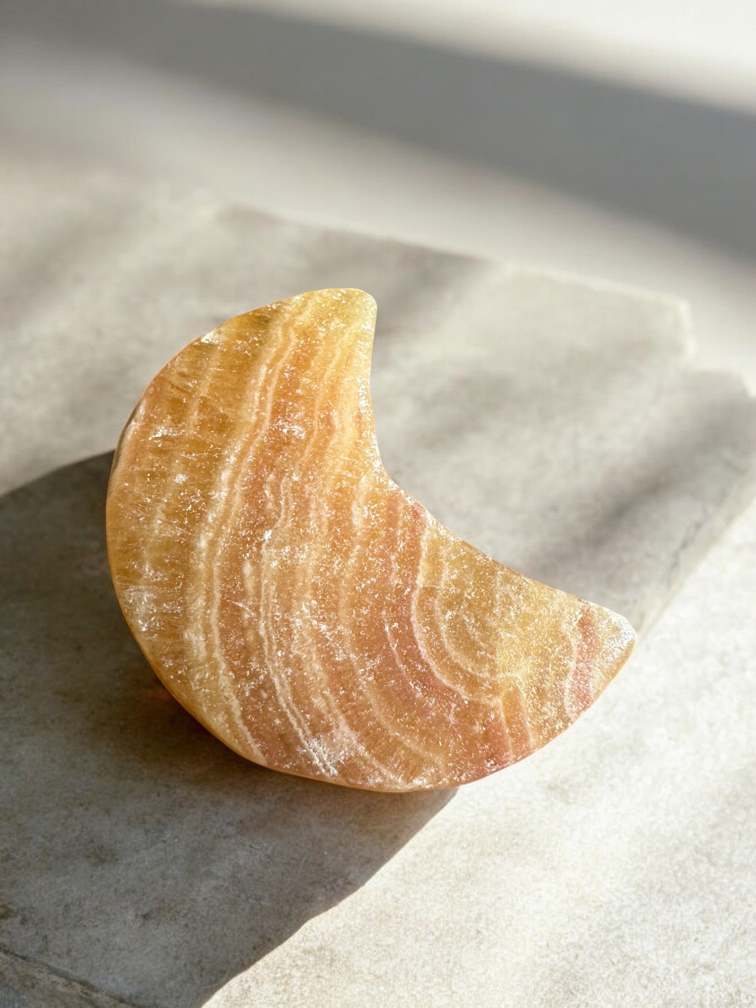 Orange calcite crystal moon front view